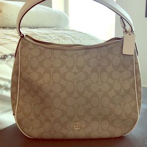 Coach Satchel in tan with white strap and details.